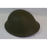 A Vintage British Army Issued Turtle Helmet Complete With Liner And Chin Strap.