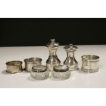 Two Hallmarked Silver Pepper mills, three Hallmarked Silver Napkin rings & a pair of cut Glass