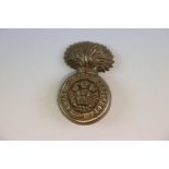 A World War Two / WW2 Royal Welsh Fusiliers Plastic Economy Grenade Cap Badge With Two Metal Blade