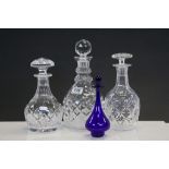 A small Bristol blue decanter and three other cut glass decanters.