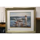 Gilt framed oil painting of Children at the Seaside playing with a Sailboat