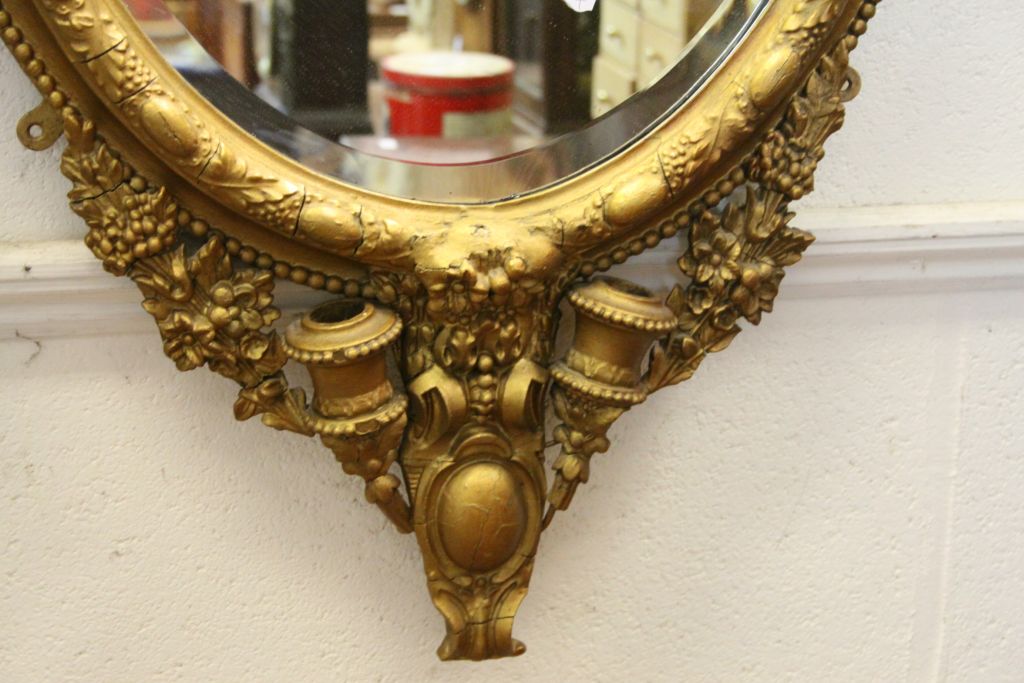 19th century oval Bevelled Glass Mirror with ornate Gilt painted frame & pair of Sconces to base, - Image 2 of 3