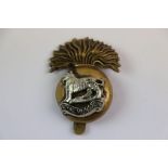 A World War One Era Royal Munster Regiment Brass Cap Grenade Badge With Slider To The Rear.