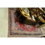 Large Eastern Red and Blue Ground Wool Rug with Stylised Floral Pattern surrounded by borders,