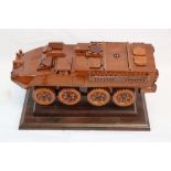A Scratch Built Wooden Model Of An Armoured Personnel Carrier Mounted On A Wooden Plinth.