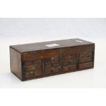Early 20th century Apprentice Drawers, the lid revealing compartment above three rows of four