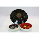 Three Poole Delphis Pottery ceramic dishes, the largest approx 27.5cm diameter, the smallest with