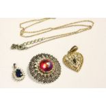 Three items of mixed costume jewellery to include two Pendants, one with necklace and a scarf clip