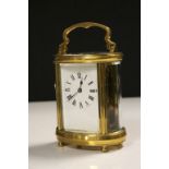 Oval cased vintage Brass Carriage Clock with bevelled Glass panels & Enamel dial, measures approx 11