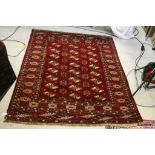 Red Ground Iranian Rug with Arabic decoration approx. 165cm x 128cm