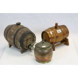 Two Coopered spirit barrels on stands and a copper effect biscuit barrel
