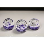 Three Caithness Glass Paperweights, blue & white design with internal Air bubbles to include;