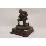 A Bronzed Figure Of A Royal Corps Of Signals Kneeling Soldier Mounted On A Wooden Plinth.