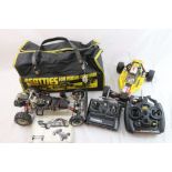 A 1/10th scale Kyosho Optima 4WD off road remote control racing car together with a spare rolling