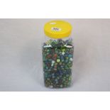 Large plastic sweet jar of mixed Glass Marbles