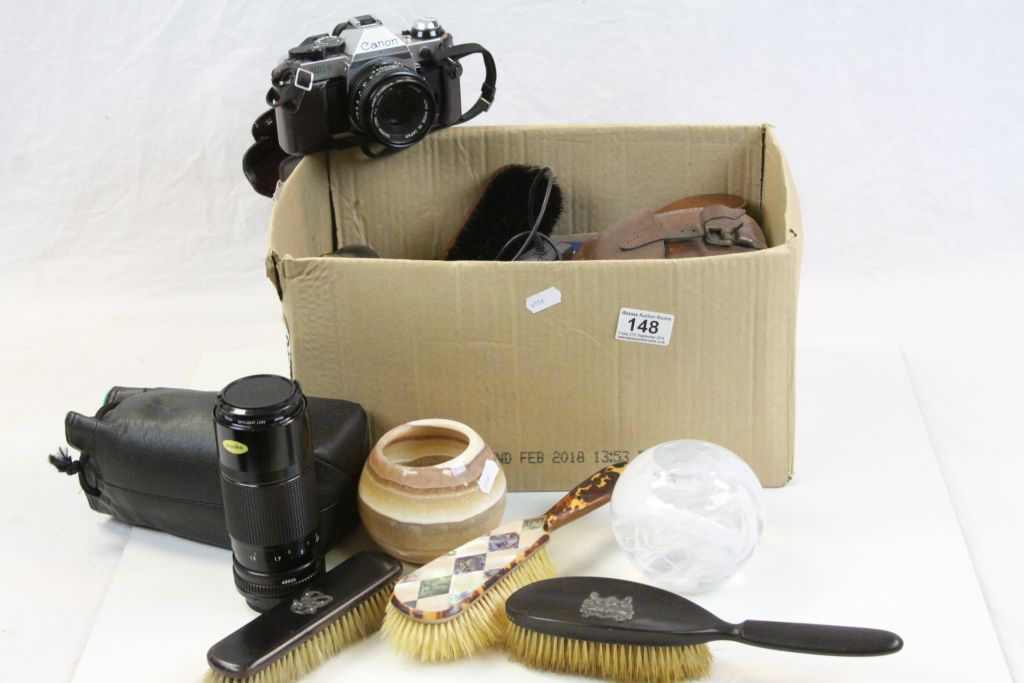 Box of mixed collectables to include Camera equipment, shoe Brushes, Kosta Boda glass tea light