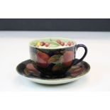 Moorcroft Pottery Cup & Saucer in "Pomegranate" pattern