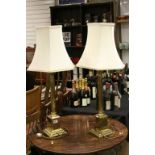 Pair of contemporary brass lamps of Corinthian form with matching shades