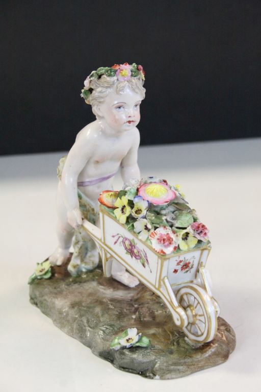 Meissen style ceramic figurine of a Garland Flower wearing Cherub pushing a wheelbarrow of Flowers - Image 2 of 7