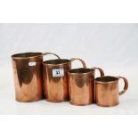 Four graduated Copper Measuring jugs