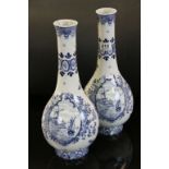 Pair of blue and white delft bottle vases with decorated panels of windmills and boats, standing