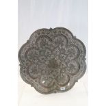 Large Indian copper scalloped edged charger with heart and stylized floral decoration