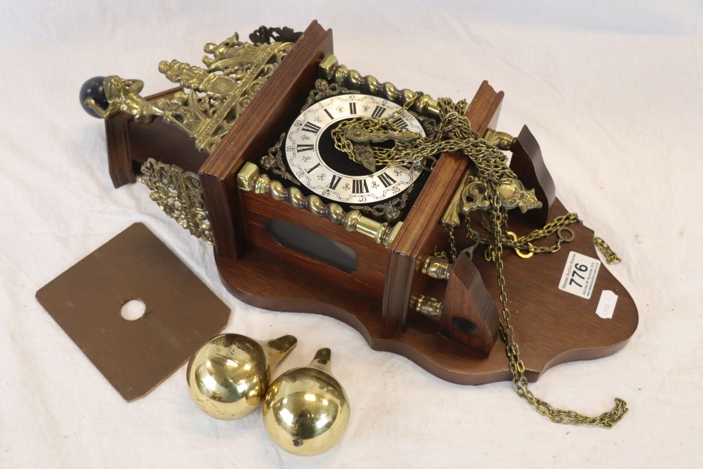 A contemporary two train wall clock with brass fittings.