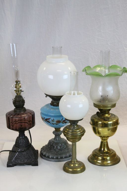 Three vintage Oil Lamps, one with painted blue Glass reservoir & white Glass shade, one with
