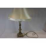 A brass table lamp of classical form with shade