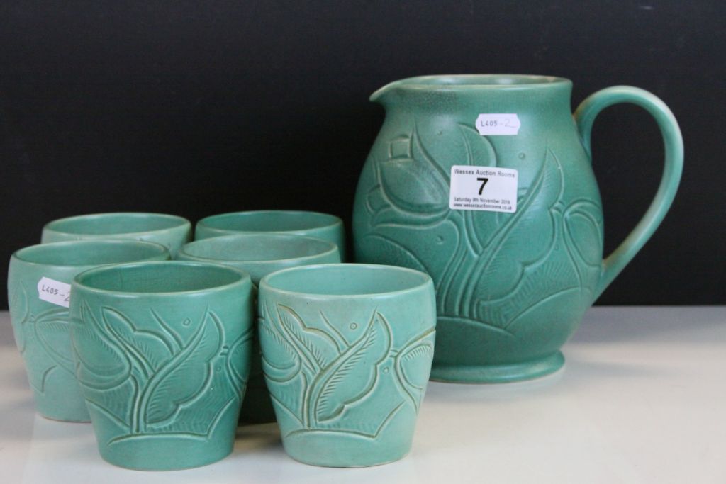 Susie Cooper Earthenware Lemonade jug & six beakers with carved Tulip decoration & matt green glaze,