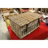 A large vintage wicker basket with lid.marked WOODGRANGE.