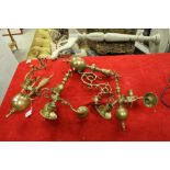 Pair of vintage brass four branched candelabra of classical form and a pair of similar wall brackets