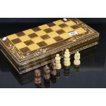 A contemporary boxed chess set with integral board.