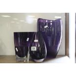 Four Amethyst colour Art Glass vases, various designs, the largest approx 30cm tall