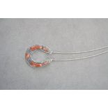 Silver horseshoe necklace set with coral