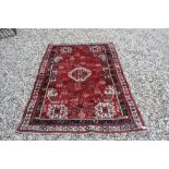 Iranian Kashgai Red Ground Rug with Geometric Stylised Pattern, 200cms x 135cms