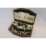 A mid 20th century oak cutlery box containing a mixed lot of plated flatware