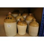 Eight stoneware flagons to include L & W Cooper pof Reading ,R Denner of Bridgwater and Wheeler and
