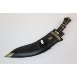 A Vintage Kukri Knife With Bone Grip And Black Leather Sheath With Decoration To The Blade, Marked