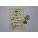 A Russian / Soviet Medal For The Defence Of Leningrad Complete With Original Issue Document.