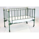 Victorian Miniature Brass & Cast Iron bed on castors, measures approx 76 x 53 x 38cm