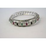 Impressive silver bangle set with rubies, sapphires and emeralds