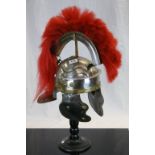 Reproduction copy of a Roman Legionaire's Helmet complete with Red plume and on a Wooden stand