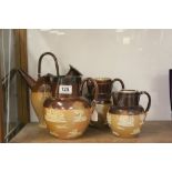 Three 19th Century Doulton Lambeth "Harvest" pattern Jugs, one with Hallmarked Silver rim plus a "