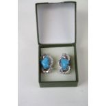 A pair of silver and turquoise stud earrings