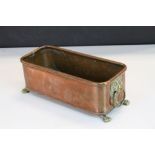 Oblong Copper planter with Brass Lion masque handles & Lion paw feet, measures approx 26.5 x 11.5