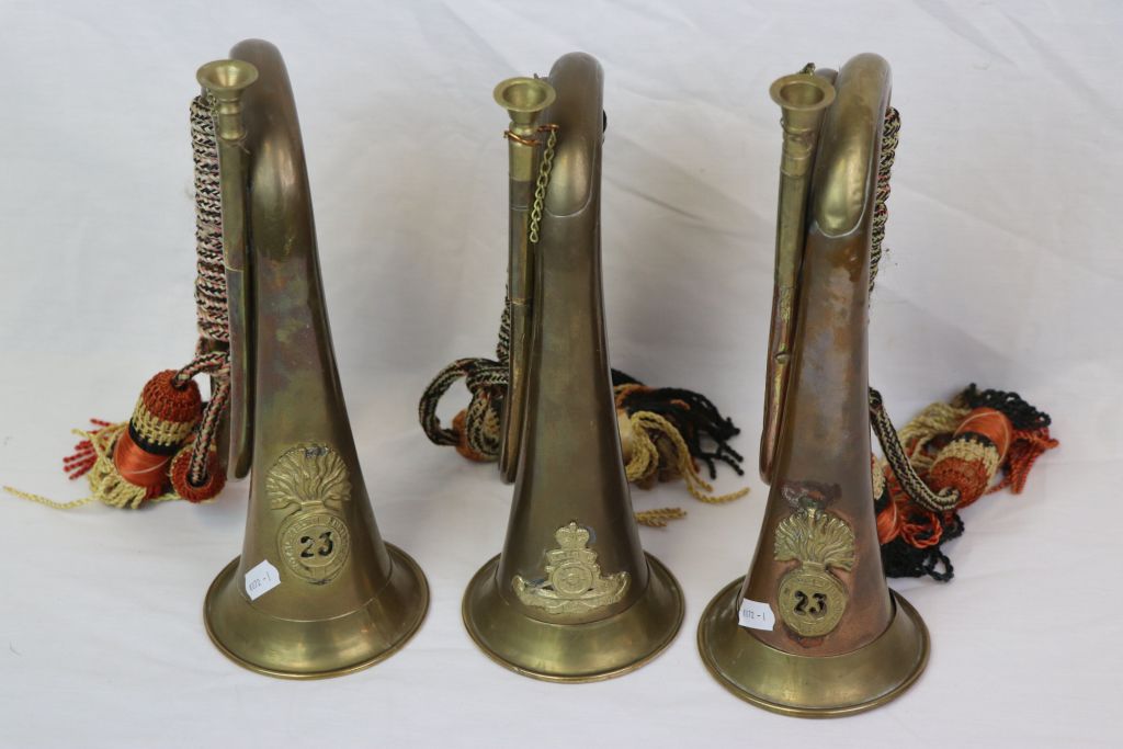 A Collection Of The British Military Bugle's, All Adorned With Military Badges To Include One To The