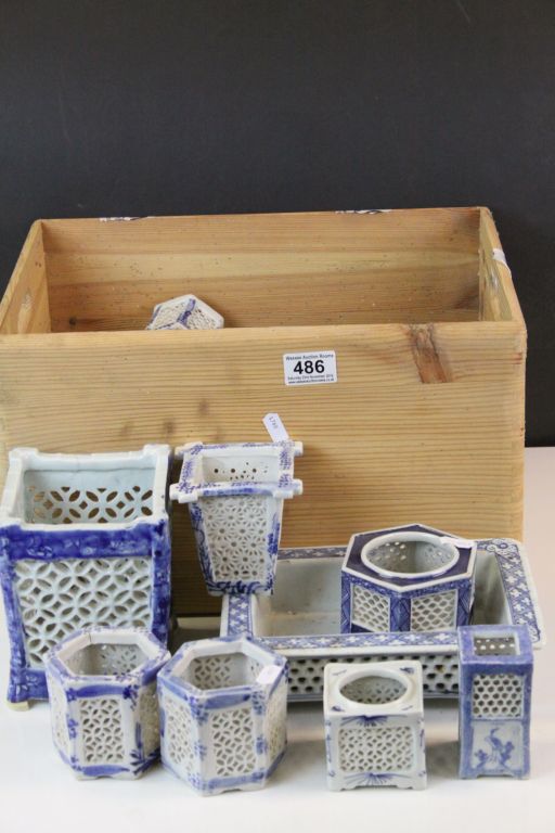 Large quantity of blue & white oriental candle stands and vases with pierced decoration