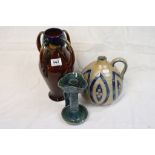 Early 20th Century art pottery vase, a similar chamber stick and a bottle vase with handle