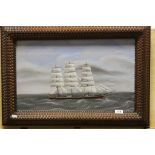 An indistinctly signed oil on board tall sailing ship in rough seas in an ornate carved frame,